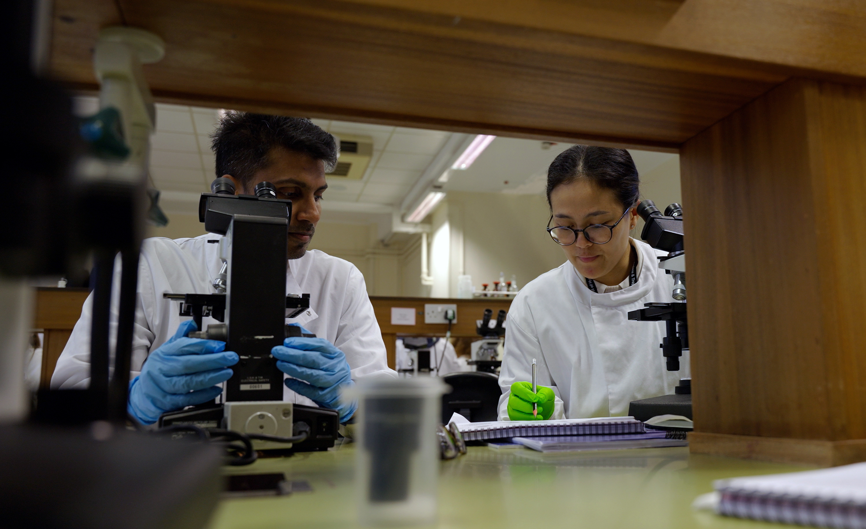 Noidavanh (right) and fellow DTM&amp;H student in a laboratory session.