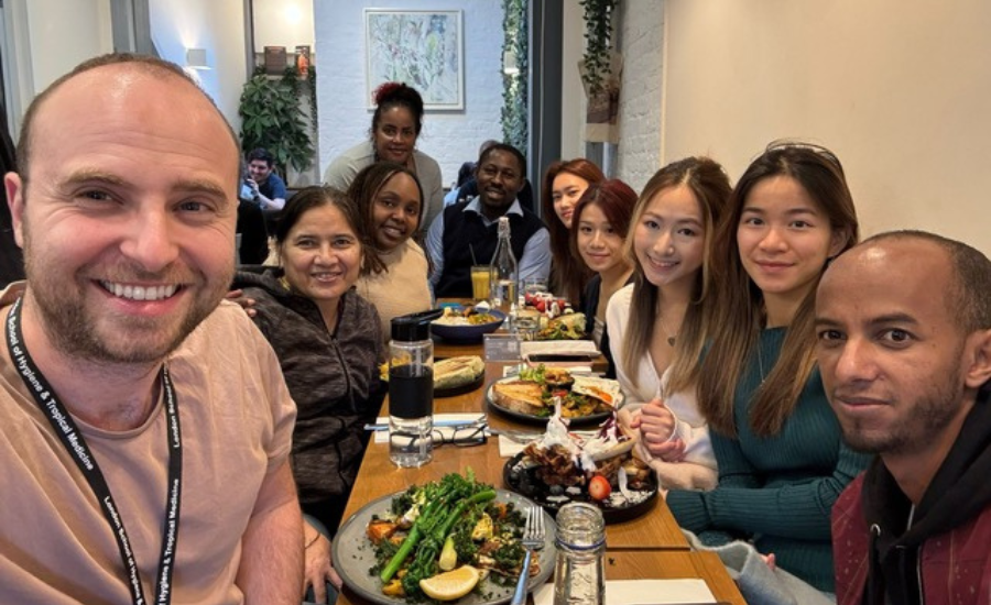 A group of MSc Public Health for Eye Care students take selfie while having lunch.