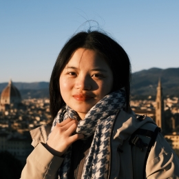Woman with short black hair and patterned scarf