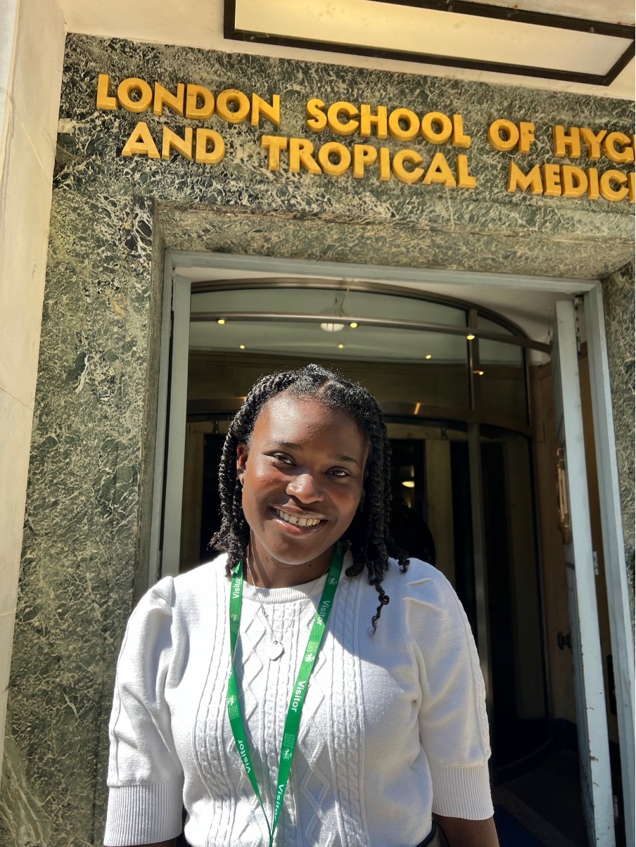Photo of Jemima Demi-Ejegi in front of LSHTM main entrance