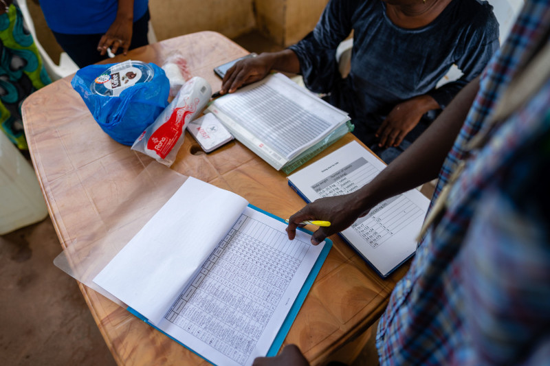 People looking at folders and papers on a table