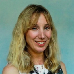 Photo of a white woman with blonde hair smiling