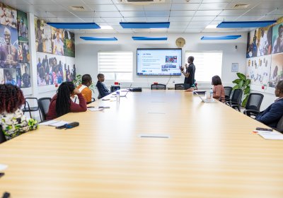 Individuals having a meeting in a seminar room