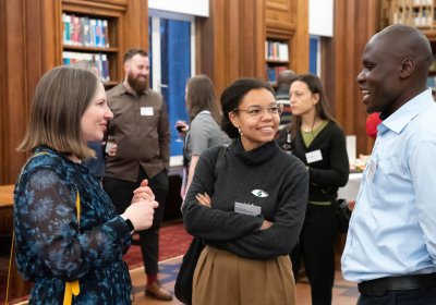 Three individuals networking in Keppel Street library 
