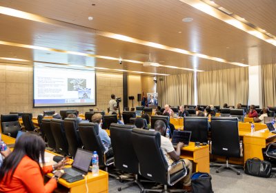 large amount of individuals having a workshop in a conference hall