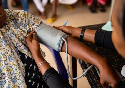 A nurse takes the blood pressure of a woman