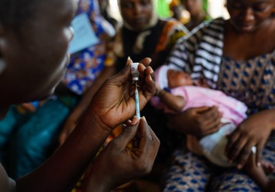 A clinician prepares a dose of vaccine at a Hospital