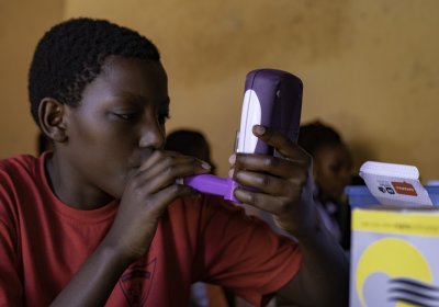 Boy taking part in SONA asthma study, blowing into machine to test lung capacity. Credit: LSHTM