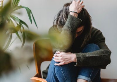 Woman curled up looking distressed