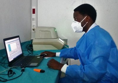 Patrick in a laboratory testing COVID-19 using PCR tests