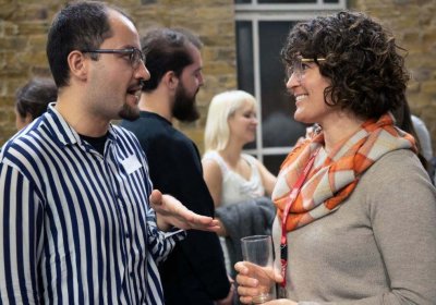 A man and a woman standing and chatting to each other