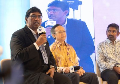 Dr Murallitharan speaking at a public forum on cancer and NCDs