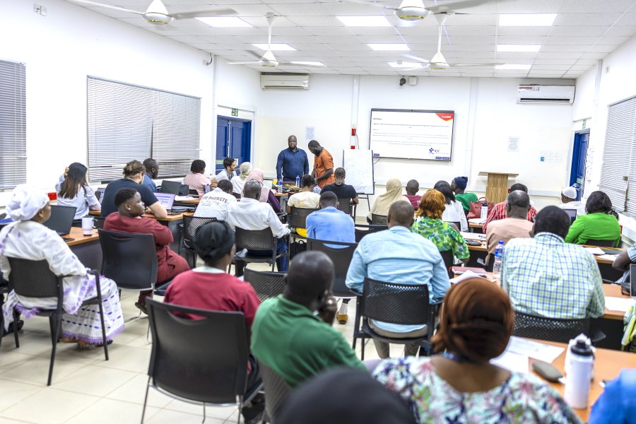 Group of individuals in a meeting room at MRCG Group of individuals in a meeting room at MRCG