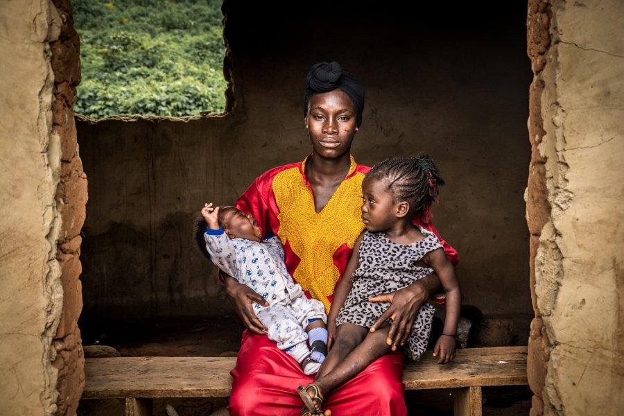 A mother holding her two babies