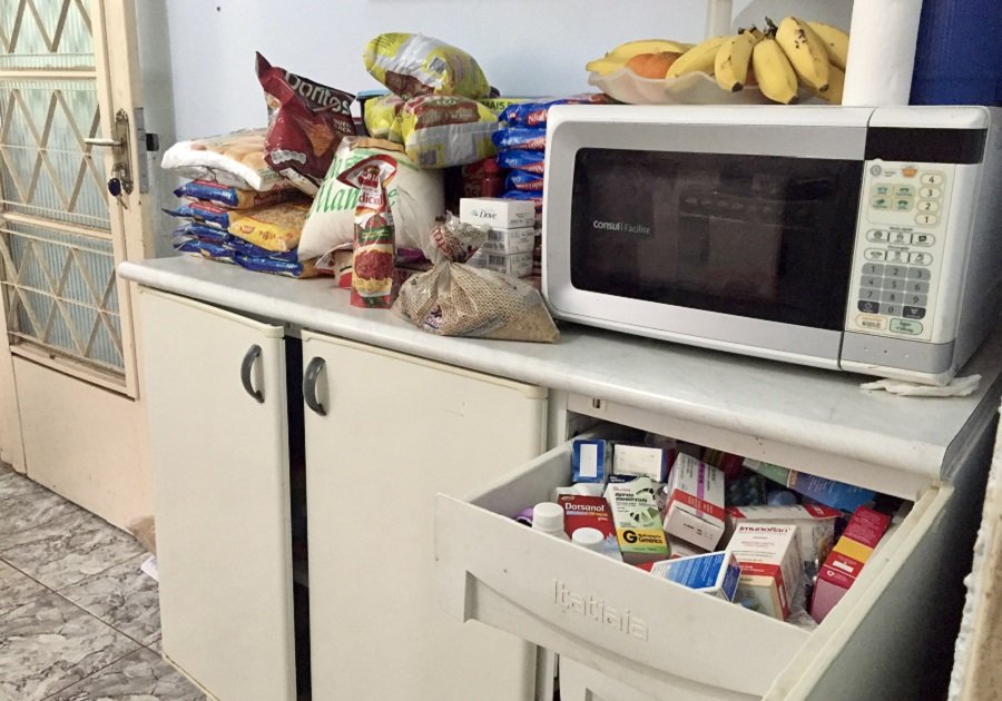 Credit: Veronkia Reichenberger By Veronkia Reichenberger. In Brasilia, in a participant's house, we can see food on the counter and the medicine drawer open