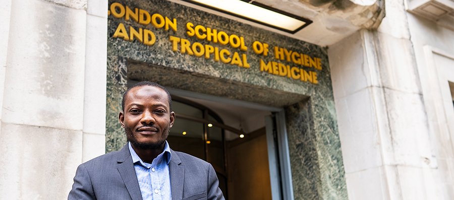 Muftau stands outside the LSHTM entrance on Keppel Street