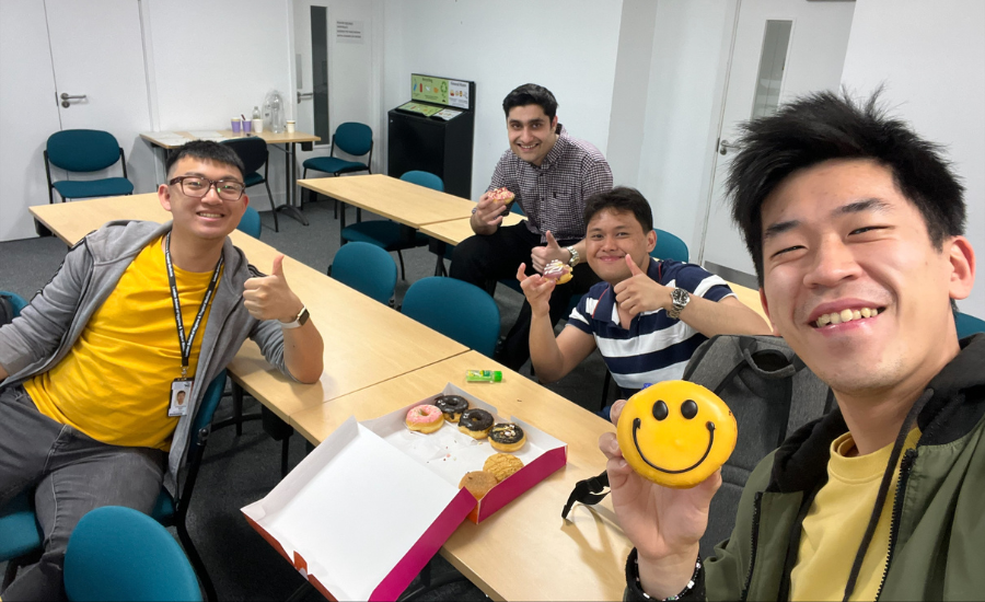 Henry (front) and students recharging themselves for revising more immunology 4 students in a LSHTM classroom taking a selfie