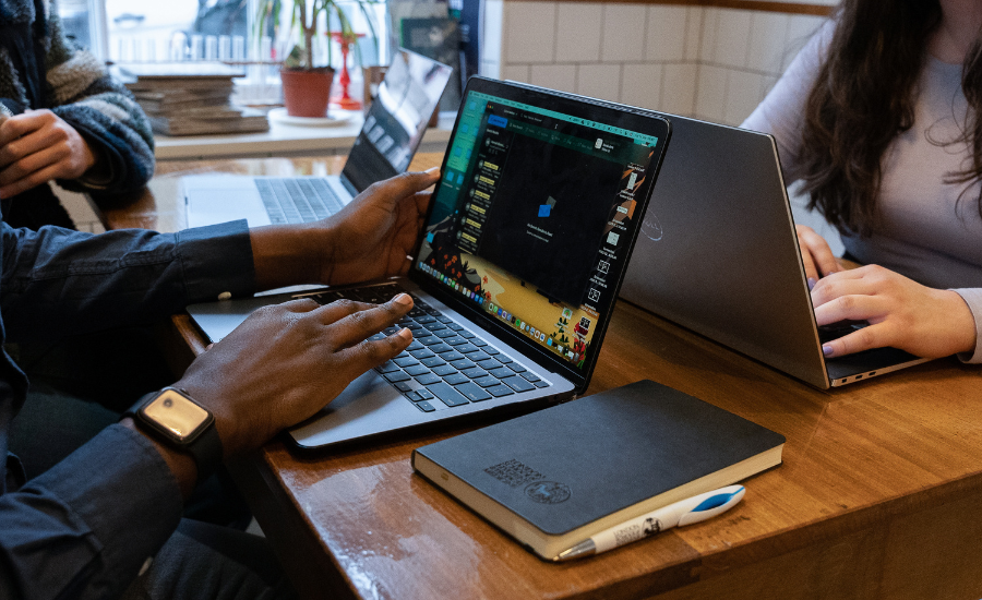 Students using their laptop in a cafe. Students using their laptop in a cafe.