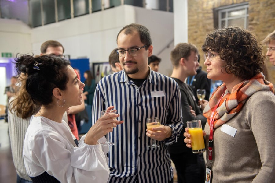 Three people chatting with drinks