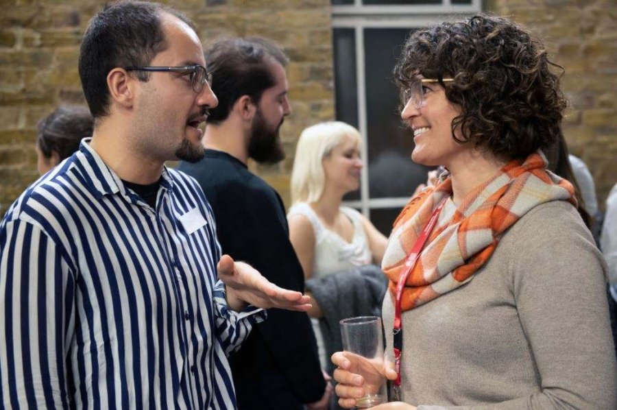 a man and a woman standing and chatting to each other