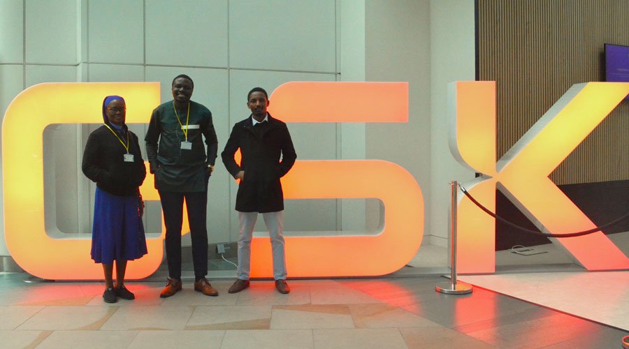 Team in front of GlaxoSmithKline logo