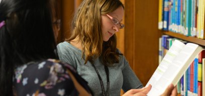 Looking at books in library