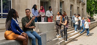 Students chatting and relaxing in front of Keppel Street building