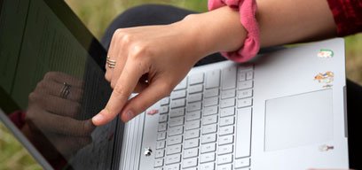Close up of student working on laptop